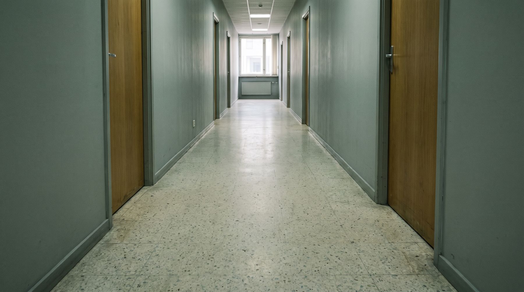 An empty office corridor with closed doors